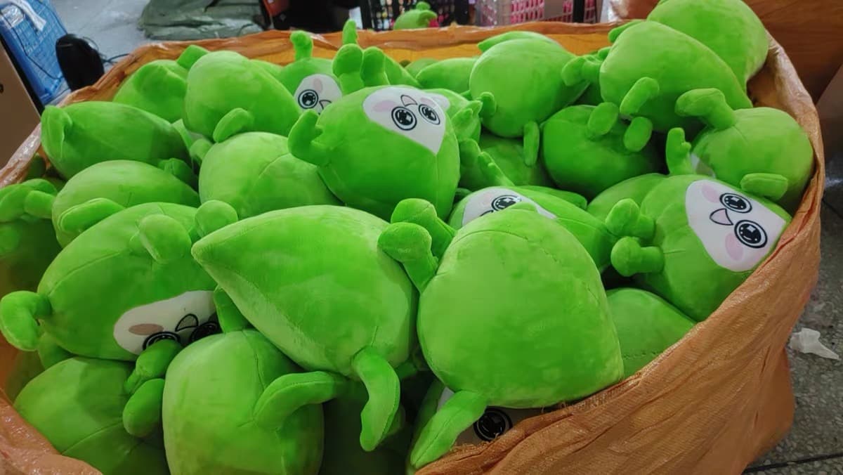 Factory workers assembling bulk toy orders