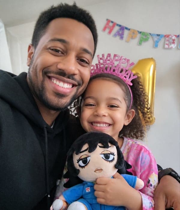Father and daughter at a birthday celebration with a custom anime-style fashion doll plush toy
